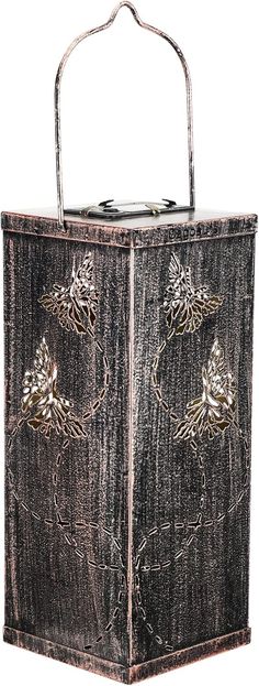 a metal box with flowers on the front and sides, is shown in this image