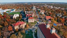 an aerial view of the campus and surrounding buildings in fall colors, including trees with leaves on them