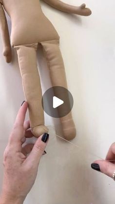 someone is making a doll out of fabric