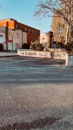 an empty parking lot with graffiti written on it