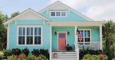 a blue house with an american flag on the front door