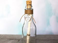 a message in a bottle with a pen sticking out of the top, on a wooden table