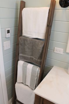 towels stacked on top of each other in a bathroom