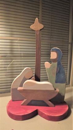 a wooden nativity scene with a baby jesus in the mangeracle and a star