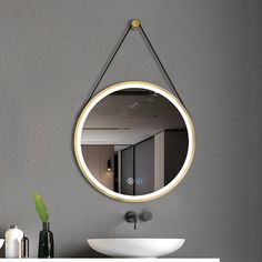 a bathroom mirror hanging on the wall above a sink