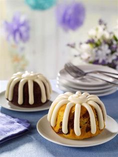 two bundt cakes with icing sitting on plates