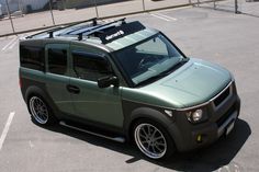 a green and black car parked in a parking lot