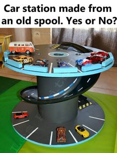 a table with cars and trucks on it in the shape of a train track is shown