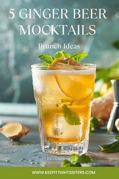 a glass filled with lemonade and mint on top of a table