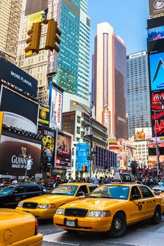 taxi cabs are lined up on the street in times square, new york city