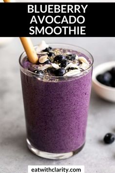 blueberry avocado smoothie in a glass with an oatmeal garnish