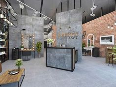 the interior of a hair salon with brick walls and exposed ceilings, potted plants on tables