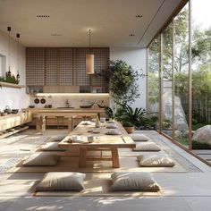 a large open room with lots of pillows on the floor and tables in front of it