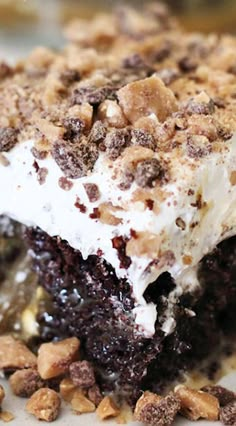 a close up of a piece of cake with ice cream and chocolate chips on it