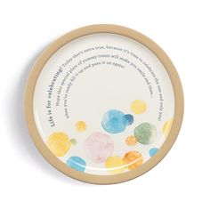 a small plate with colorful circles on it and a poem written in the bottom corner