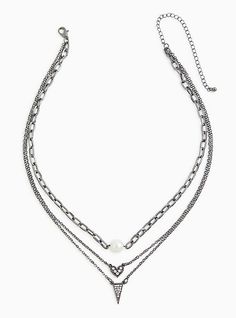 Make an eye-catching statement with this layered necklace, featuring a faux pearl charm, a heart pave charm, and ending with a triangle pave charm. Lobster clasp. 19-21” with 5” extender. Base metal. Imported. The best plus size women's hematite-tone pave triangle layered necklace necklaces in silver. Torrid is your destination for the freshest spring and summer styles. Triangle Necklace, Fitted Wedding Dress, Pretty Necklaces, Summer Styles, Faux Stone, Pearl Charms, Layered Necklace, Bra Cups, Base Metal