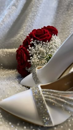 wedding shoes and bouquet on white fabric