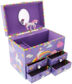 an open purple box with unicorns and rainbows on it's sides is shown