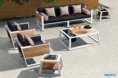 an outdoor seating area with coffee table and couches