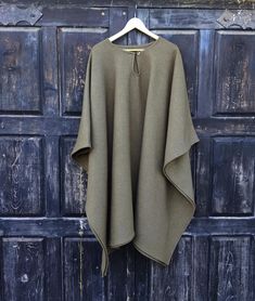 Wool blanket poncho cape, ruana One size fits all  -  men or women.  Available with hood or without hood Available in brown squares and gray (Charcoal/ Grey Salt & Pepper) 100% wool CARE: Hand-wash and hang to dry, light iron if needed, or dry clean. Length of poncho is 90cm or 35.5inch Length of arm (from neck to arm end) 60cm or 23.5inch Wool Blanket Poncho, Outdoor Poncho With Cape Shape, Oversized Cape Poncho For Outdoor, Cozy Wool Poncho One Size, Wool Cape Poncho One Size, Wool Poncho Cape One Size, Oversized Solid Color Cape, Cozy Wool Poncho Cape, Cozy Brown Wool Poncho