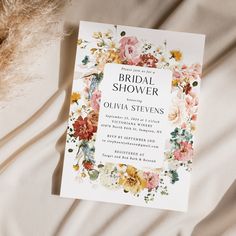 a floral bridal shower is on the bed