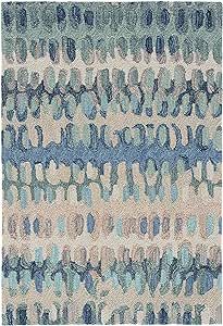 a blue and beige rug with an abstract design on the bottom, in different colors