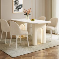 a white table with four chairs around it