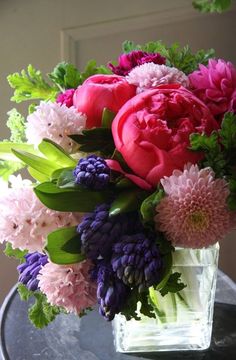 a vase filled with pink and purple flowers