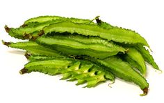 some green beans are on a white surface