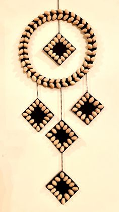 a decorative item hanging on a wall in the shape of a circle and four squares