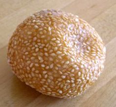 a sesame seed ball sitting on top of a wooden table