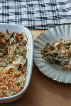 a casserole dish with meat and vegetables in it on a table next to a plate