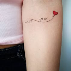 a woman's arm with a tattoo that reads made in peace and a red heart