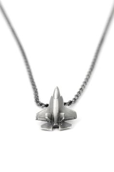 "Welcome to TomerM Jewelry! Another piece in my fighter jet jewelry series, this whimsical fighter jet pendant necklace is based on the F-35 Lightning II, a family of single-seat, single-engine, all-weather, stealth, fifth-generation, multirole combat aircraft. Rich in detail, I softly brush the silver to create a grainy texture and then add a black oxide finish that will hug the grooves and edges, giving the jet so much more depth dimension and Stealth finish.. ABOUT THIS NECKLACE ✈ Entirely ha Jet Jewelry, F 35 Lightning, F 35 Lightning Ii, Grainy Texture, Pilot Gifts, Fighter Pilot, Necklace Sterling Silver, Gift Necklace, Mens Gifts