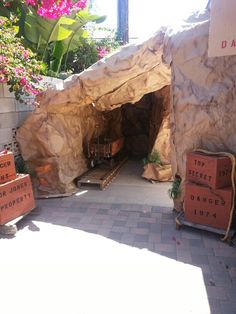 cardboard boxes are stacked up in front of a rock structure with the words top secret on it