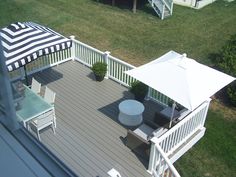 an overhead view of a deck with chairs and umbrellas on it's side