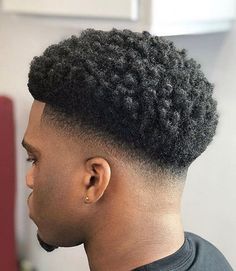 Drop Fade Afro. This textured afro fade is a stylish, versatile and trendy hairstyle for black men wanting a modern variation on the classic look. A fresh haircut that pairs a sleek, cool fade on the sides and back with longer, afro-textured hair on top will elevate your aesthetic, creating a charming look that stands out. Hair Cuts Black Man, Mid Taper Fade Haircut Black Men, Taper Fade Afro, Afro Fade Haircut, Afro Hair Fade, Black Man Haircut Fade, Temp Fade Haircut, Taper Fade Short Hair, Waves Hairstyle Men