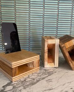 three pieces of wood sitting next to each other on top of a marble countertop