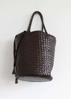 This is probably the most classic and simple of all woven baskets. the size is made to fit all for a full day at the office or simply as a carry all anywhere.    handwoven bucket basket buffalo calf leather lining    dimensions:    - width : 10.6in / 27cm  - length : 78in / 20cm  - depth : 86in / 22cm  - handle drop length : 5.9in / 15cm Luxury Handwoven Brown Bucket Bag, Luxury Brown Handwoven Bucket Bag, Brown Straw Bag With Dust Bag For Everyday Use, Luxury Basket Bag For Everyday, Luxury Basket-shaped Everyday Bag, Brown Woven Leather Basket Bucket Bag, Brown Woven Leather Bucket Bag, Everyday Intrecciato Basket Shoulder Bag, Brown Leather Straw Bag With Dust Bag