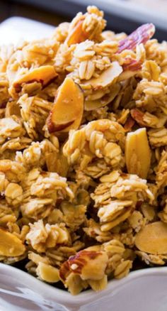 a white bowl filled with granola and apple slices