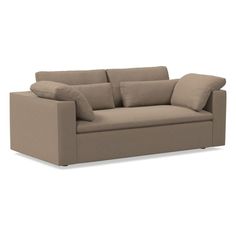 a beige couch with pillows on it