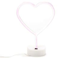 a heart shaped neon light on a white surface with a cord attached to the end