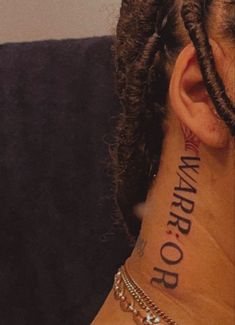 a close up of a person with tattoos on their neck