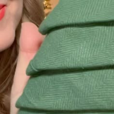 a close up of a person wearing green clothing