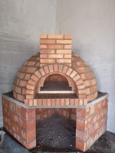 an outdoor brick pizza oven in the process of being built