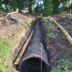 a large pipe laying in the middle of a field