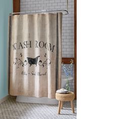 a bathroom with a shower curtain that says wash room and has a cow on it