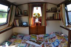 an image of the inside of a camper with books on it's bed