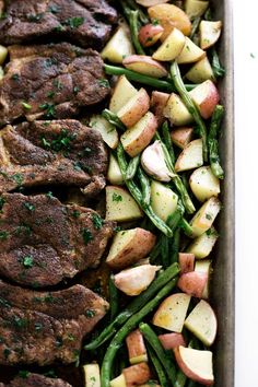 steak, potatoes and green beans in a roasting pan with parsley on top