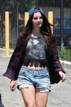 a young woman walking down the street with her skateboard